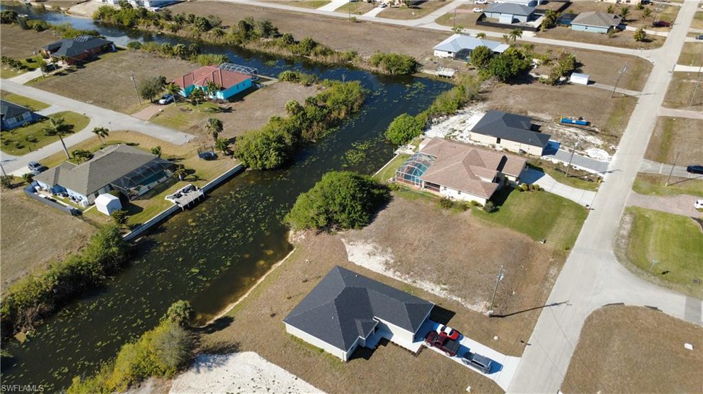 View of property location featuring a large body of water and nearby suburban area