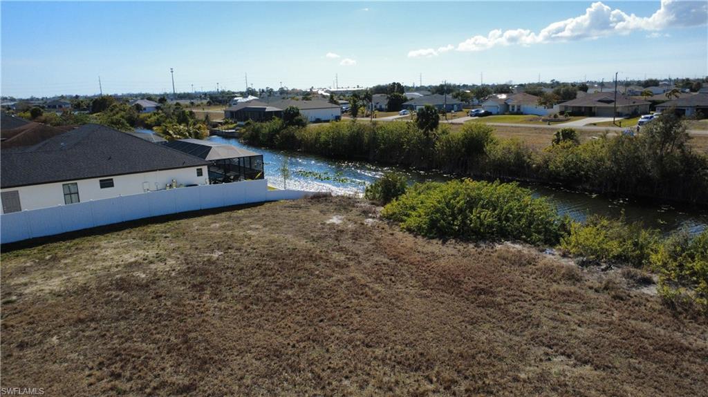 View of yard featuring a residential view and a water view