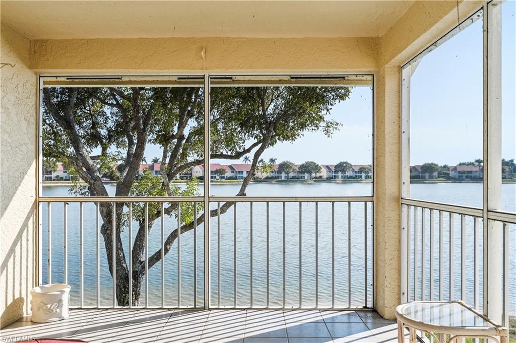 Unfurnished sunroom with a water view and a residential view