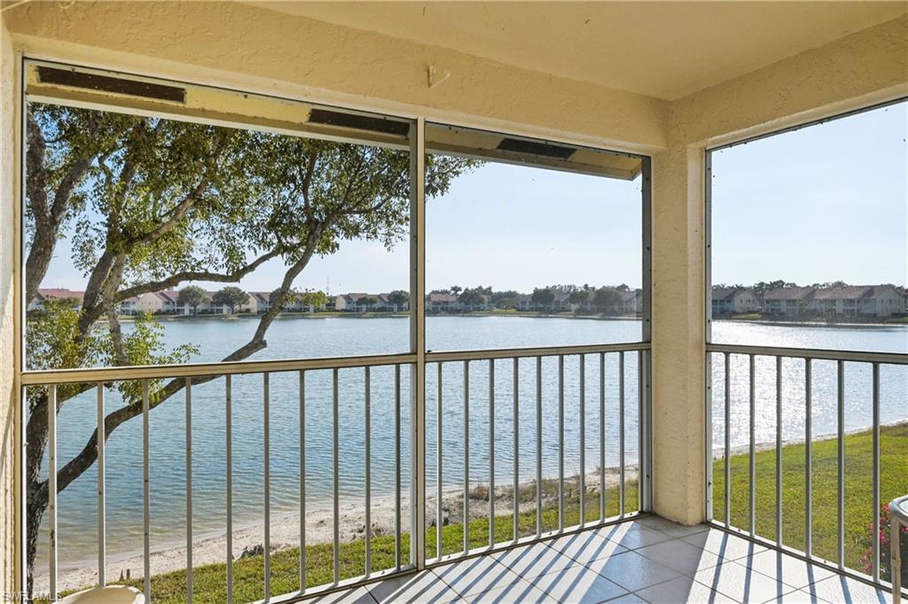 Unfurnished sunroom featuring a water view and a residential view