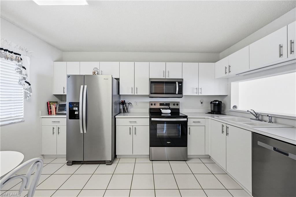 Kitchen with stainless steel appliances, plenty of natural light, and light countertops