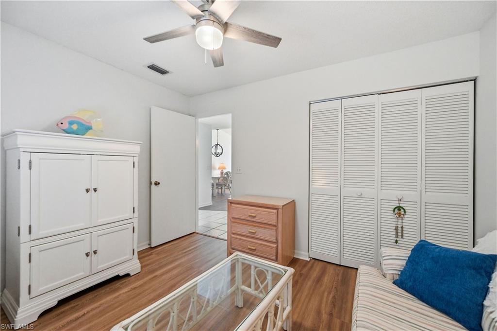 Bedroom with light wood-style floors, a closet, and ceiling fan