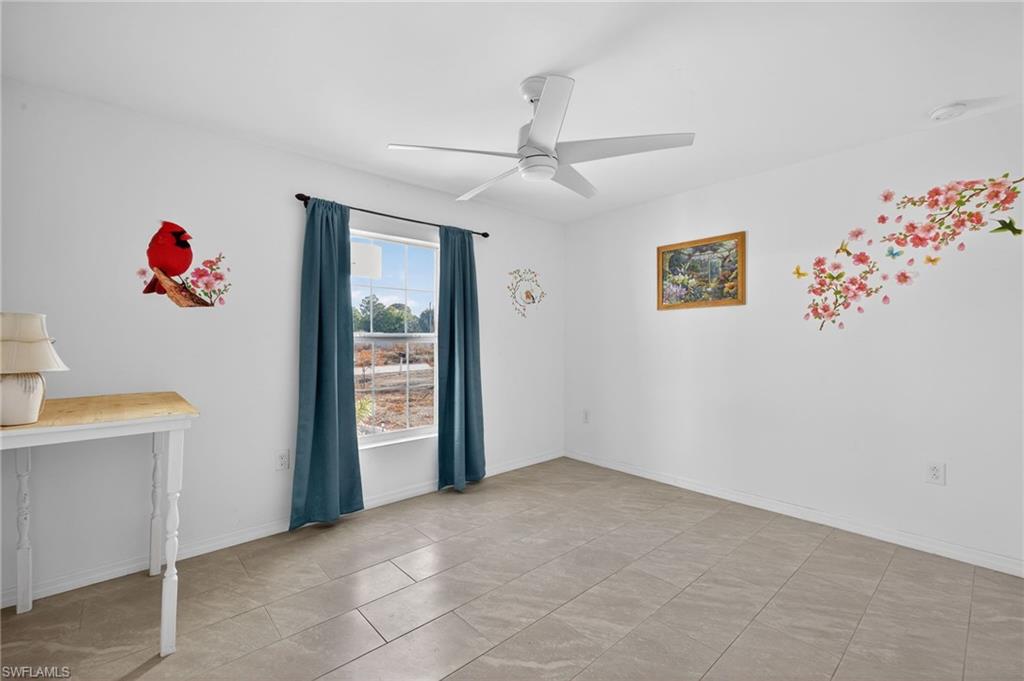 Bedroom featuring ceiling fan and baseboards