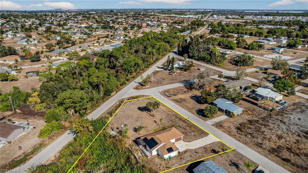 Aerial view of residential area with property parcel outlined
