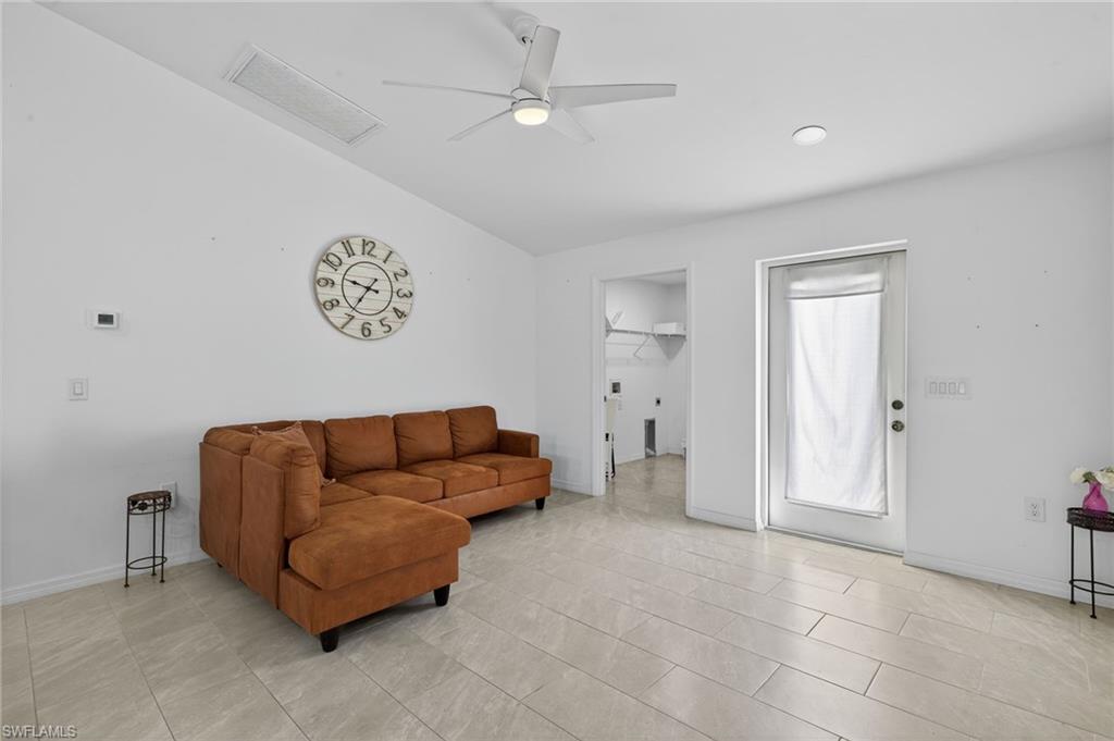 Living area with lofted ceiling and a ceiling fan