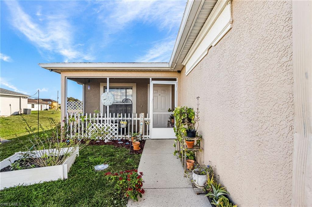 Property entrance featuring stucco siding and a sunroom
