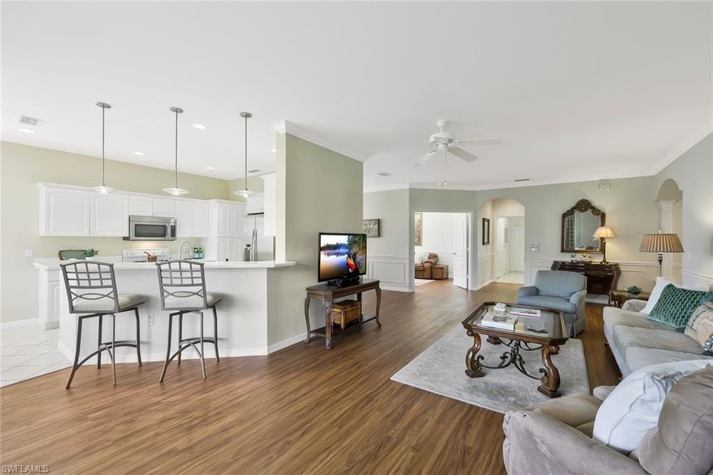 Living room to kitchen with breakfast bar seating.