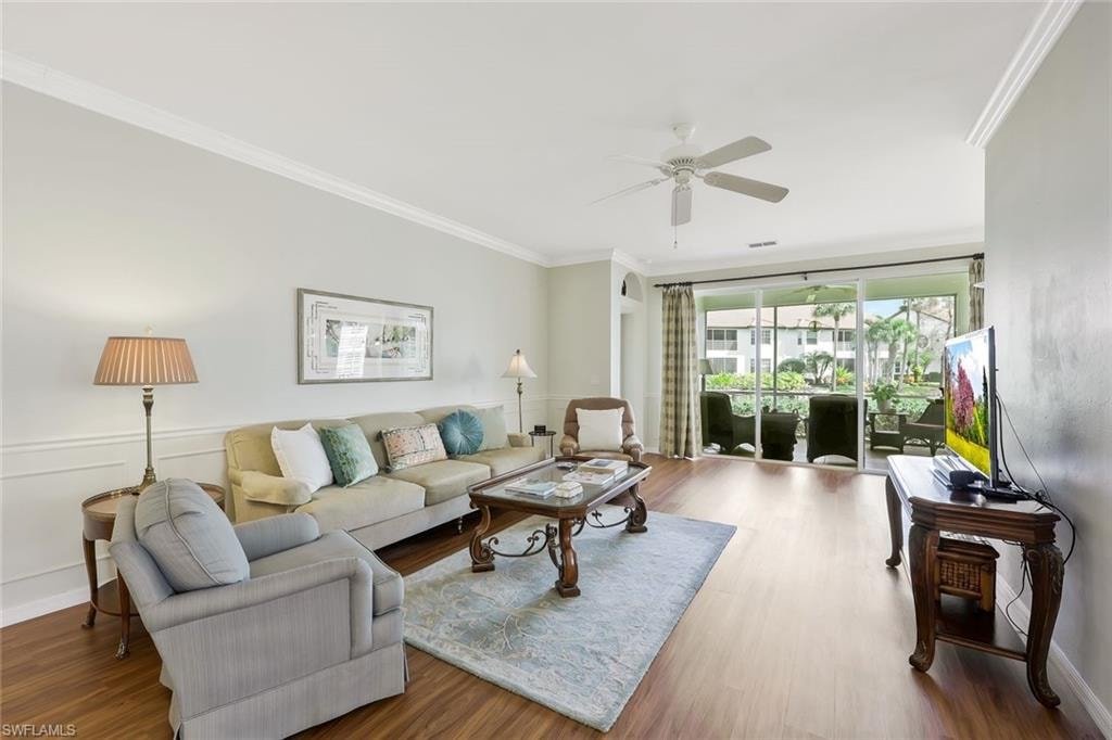 Spacious Living room with LVP flooring opens to screened lanai with serene lake views.