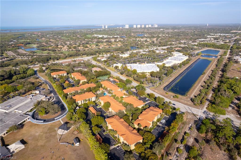Aerial view of property and surrounding area featuring a large body of water