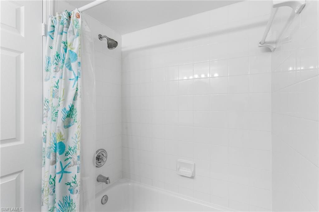 Full bathroom featuring shower / bathtub combination with curtain
