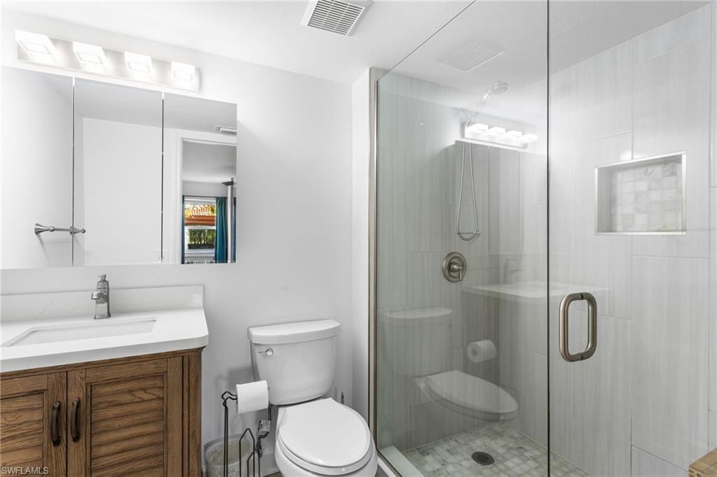 Full bath with vanity and a shower stall