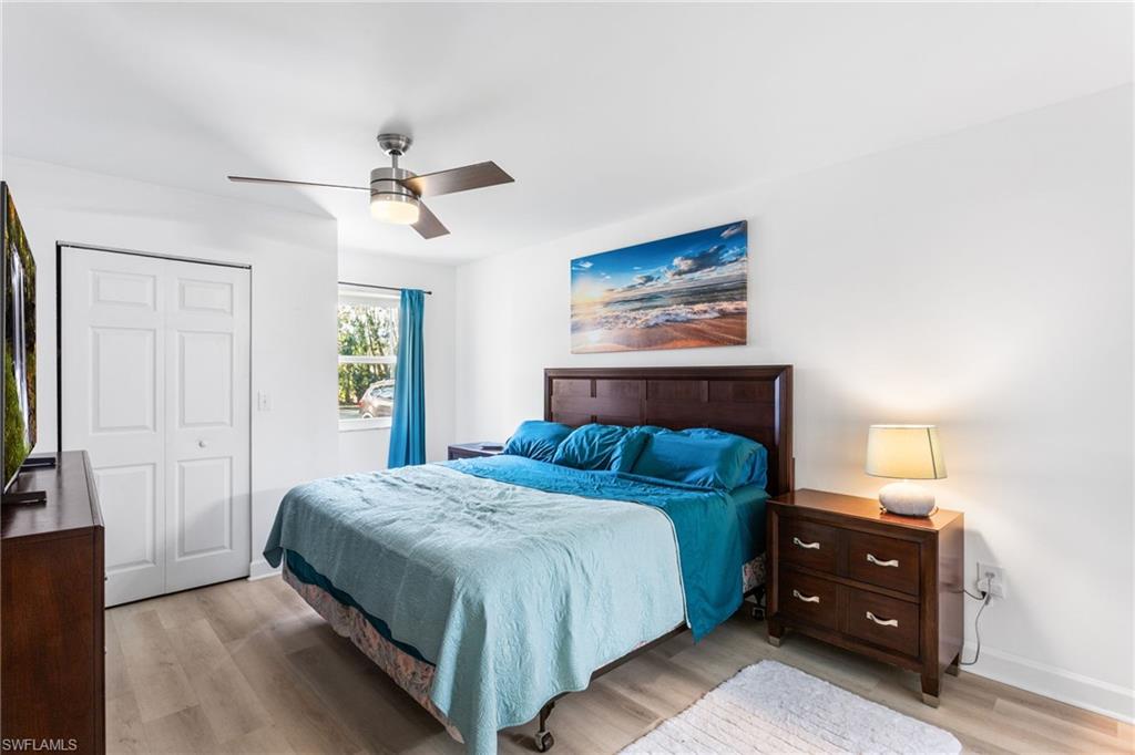 Bedroom featuring light wood-style flooring, ceiling fan, and a closet