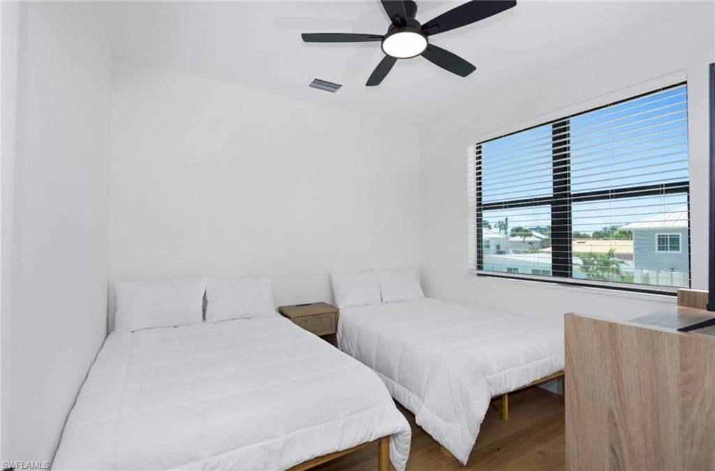 Bedroom with wood finished floors and ceiling fan