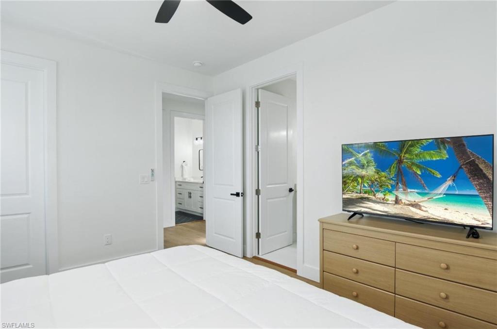 Bedroom with a ceiling fan and light wood-type flooring