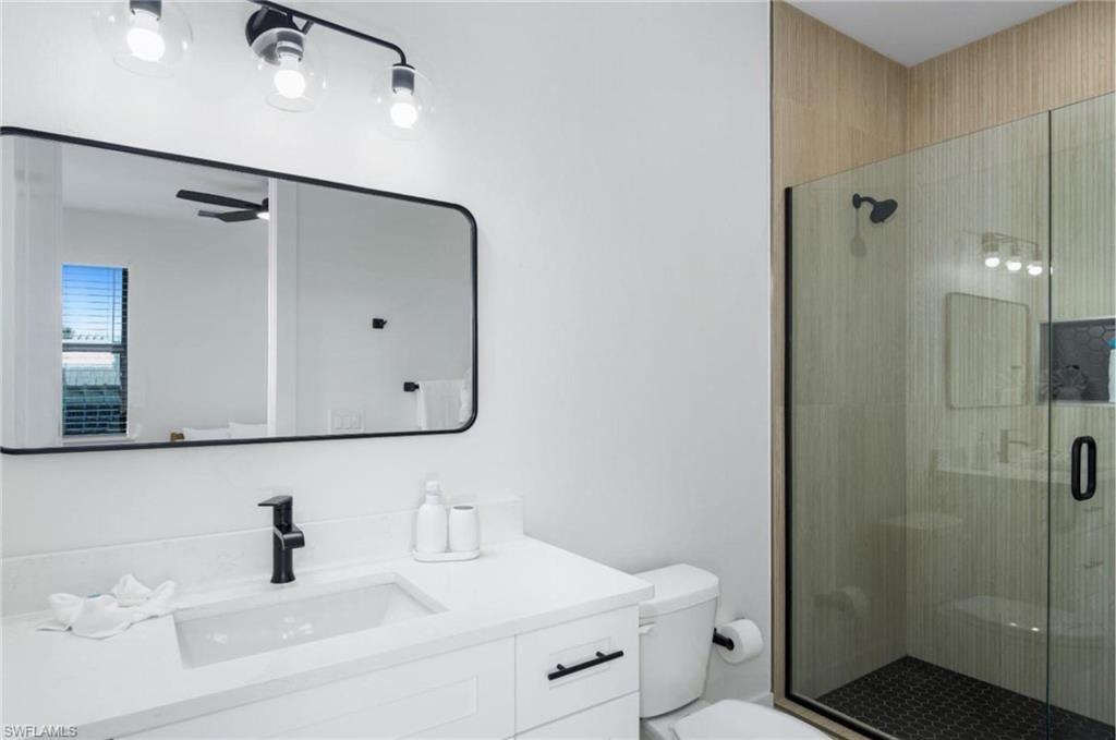 Bathroom featuring vanity and a stall shower - Virtually Edited Image