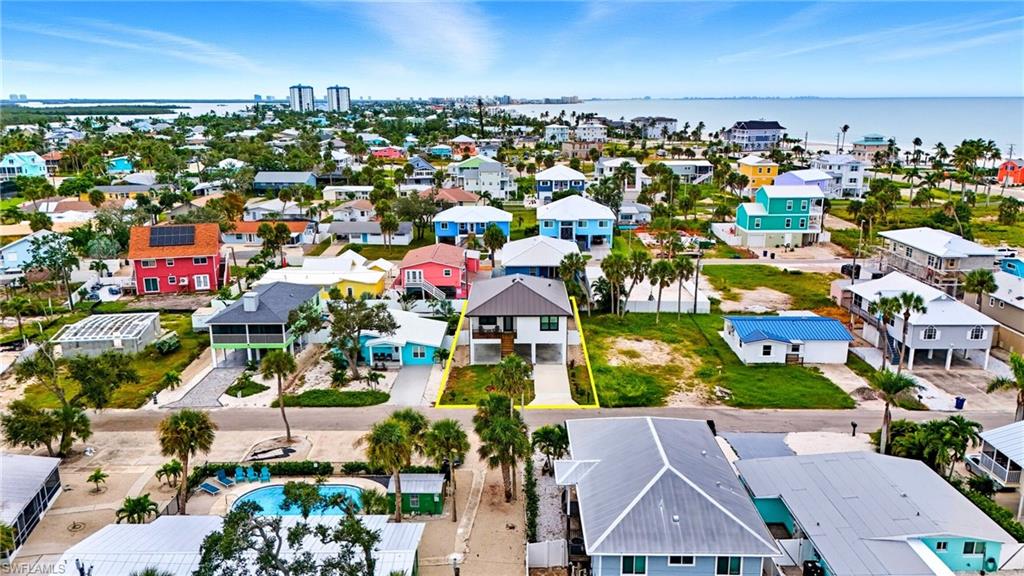 Aerial view of residential area featuring a nearby body of water - Virtually Edited Image