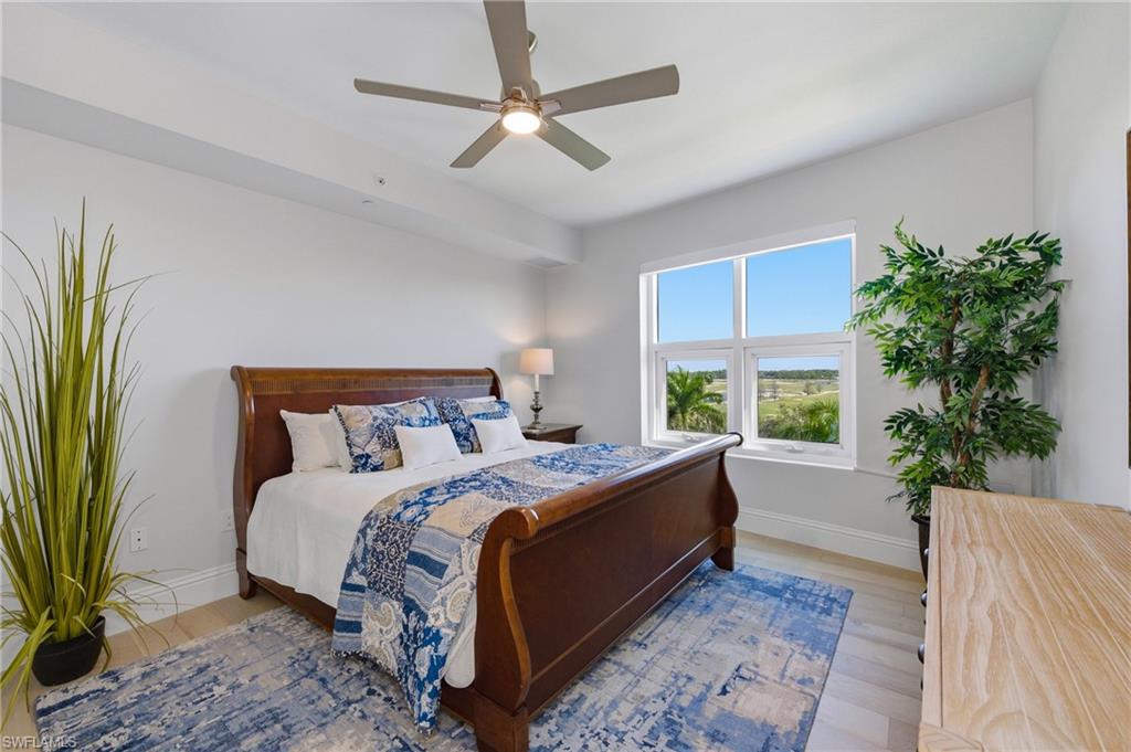 Bedroom with ceiling fan and wood finished floors