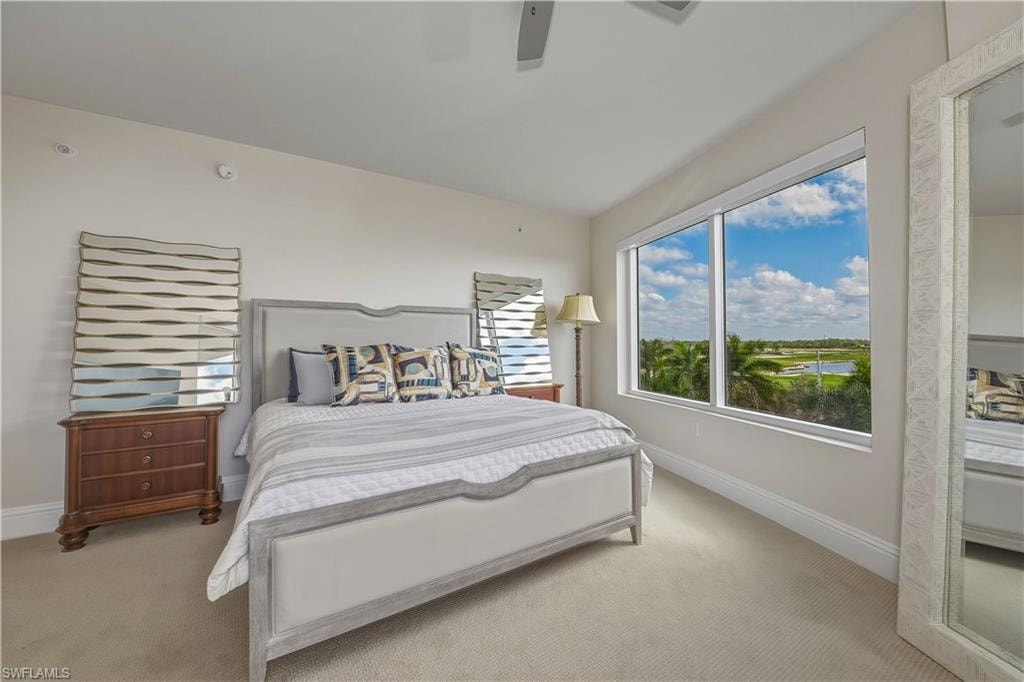Bedroom featuring light carpet and a ceiling fan