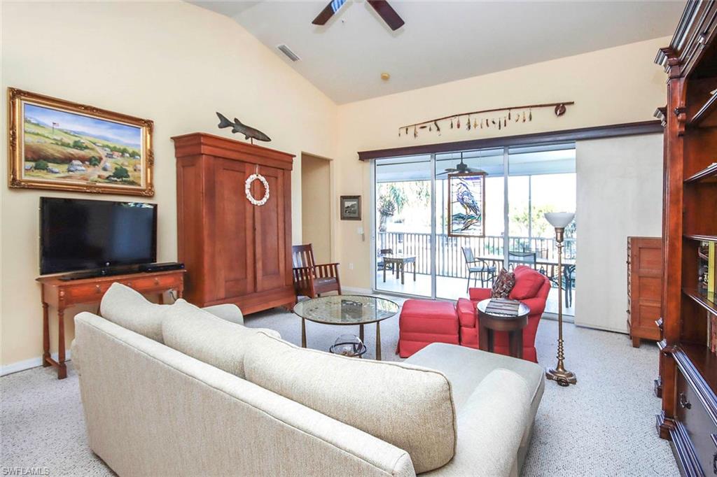Living area featuring ceiling fan and vaulted ceiling