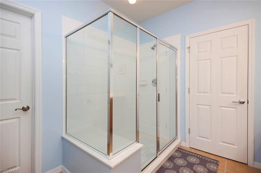 Full bathroom featuring a stall shower and tile patterned flooring
