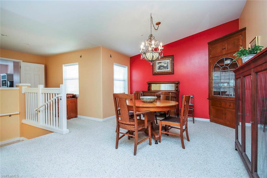 Dining area featuring baseboards and a chandelier