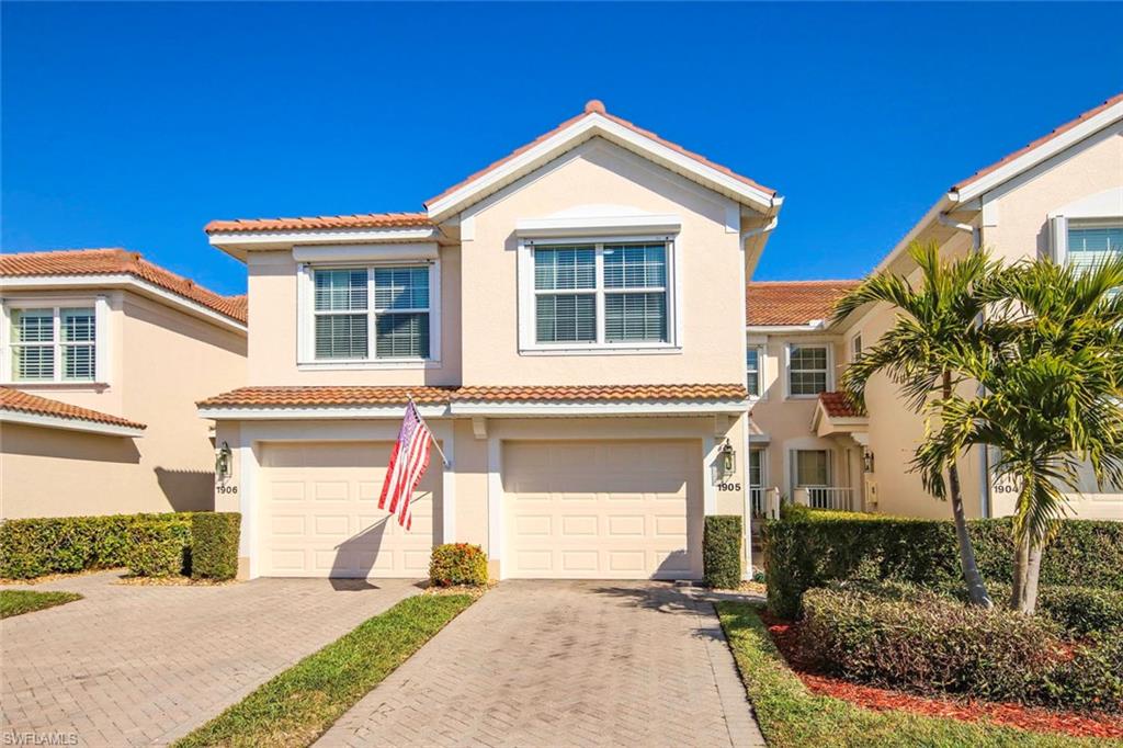 Mediterranean / spanish-style house featuring decorative driveway, an attached garage, stucco siding, and a tiled roof