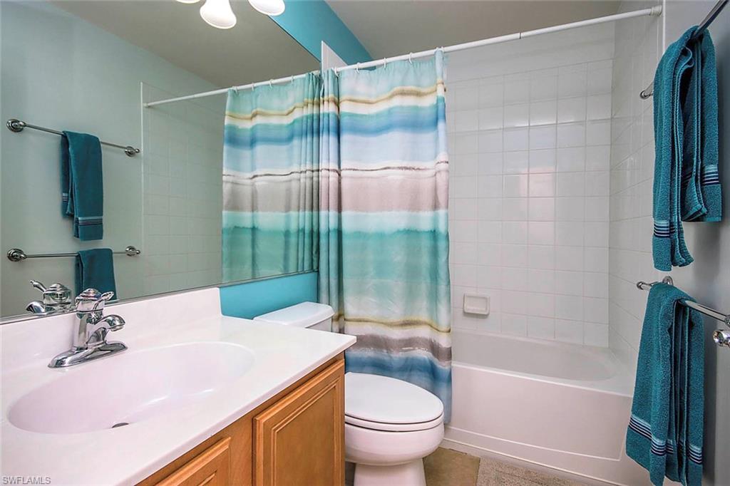 Bathroom with vanity and shower / bath combination with curtain