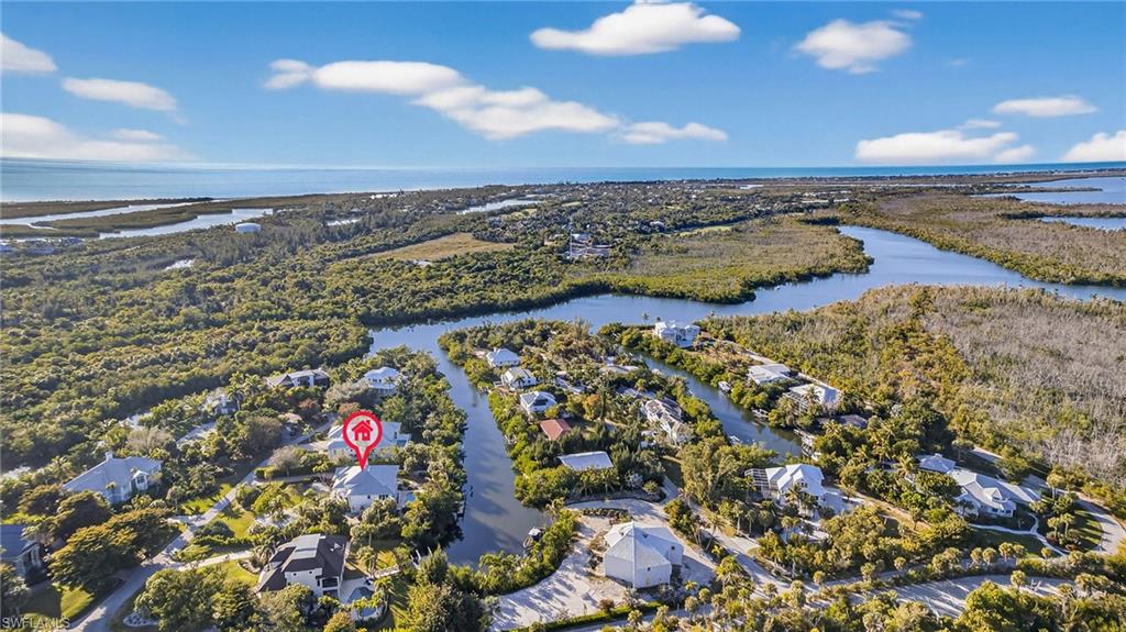 Aerial perspective of suburban area featuring a large body of water