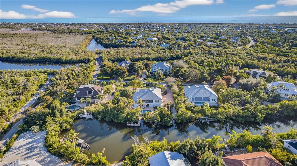 Aerial perspective of suburban area featuring a large body of water