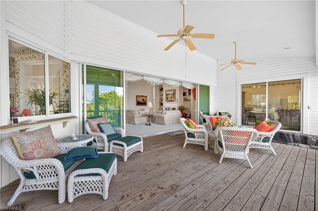 Sunroom / solarium featuring an outdoor lounge area, ceiling fan, a deck, and lofted ceiling
