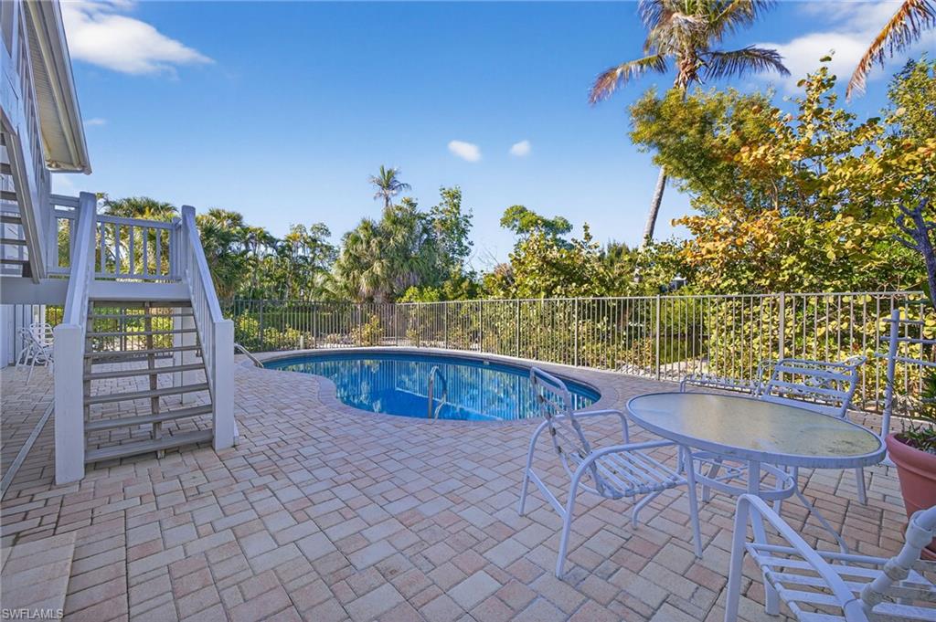 View of swimming pool featuring stairway and patio surround