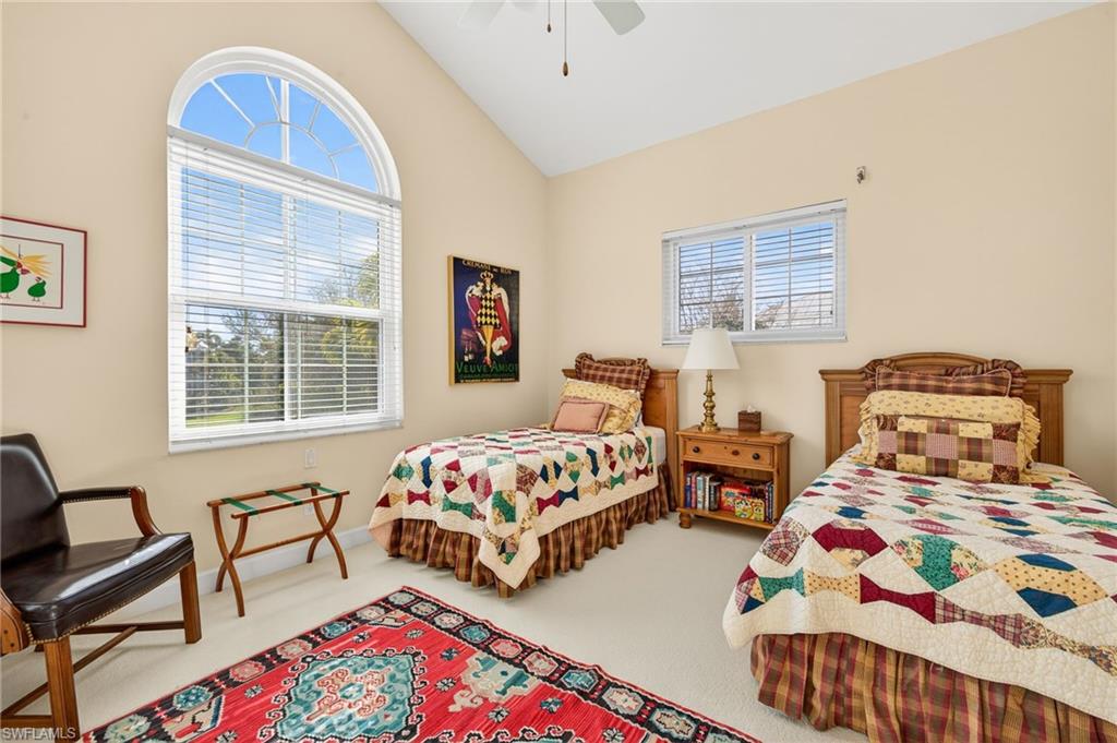 Bedroom featuring lofted ceiling, carpet floors, and a ceiling fan