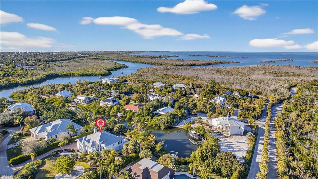 Aerial perspective of suburban area featuring a large body of water