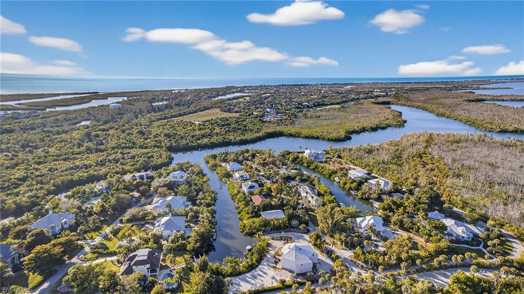 Aerial perspective of suburban area with a nearby body of water
