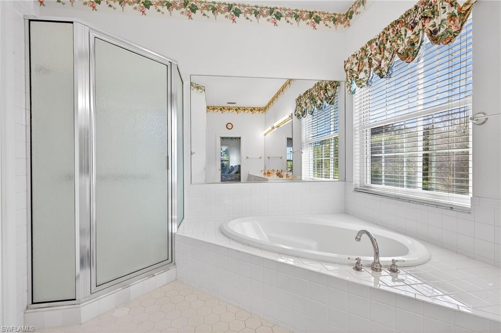 Bathroom featuring a garden tub and a stall shower