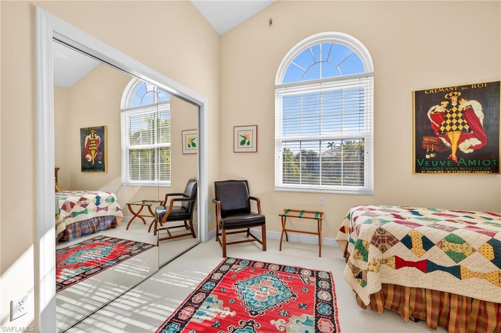 Bedroom featuring lofted ceiling and carpet floors