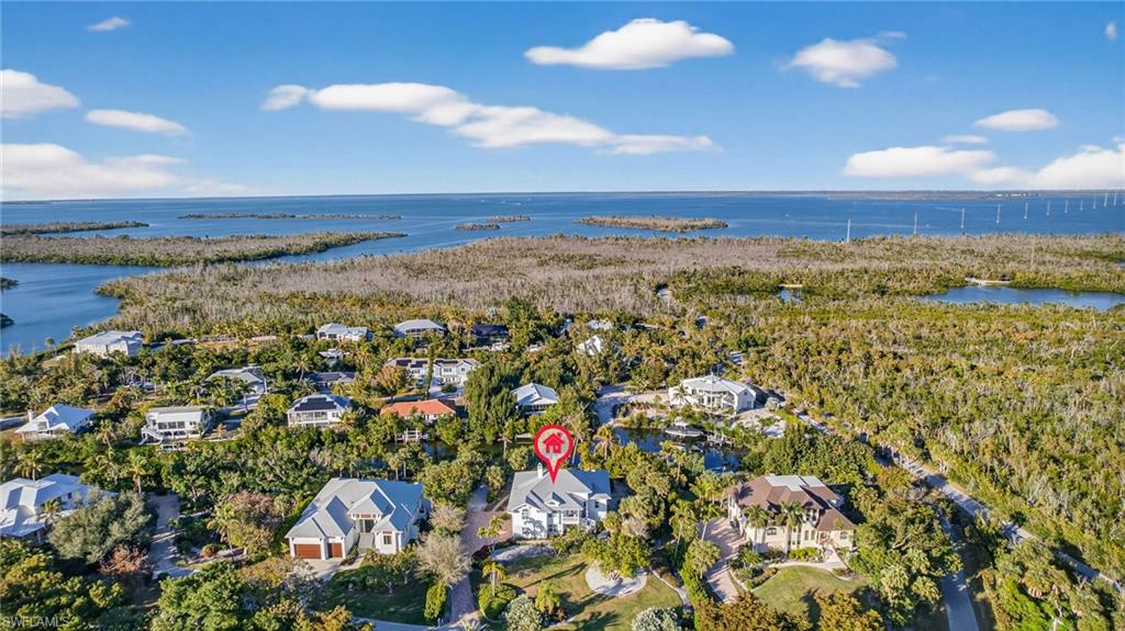 Aerial view of residential area featuring a large body of water