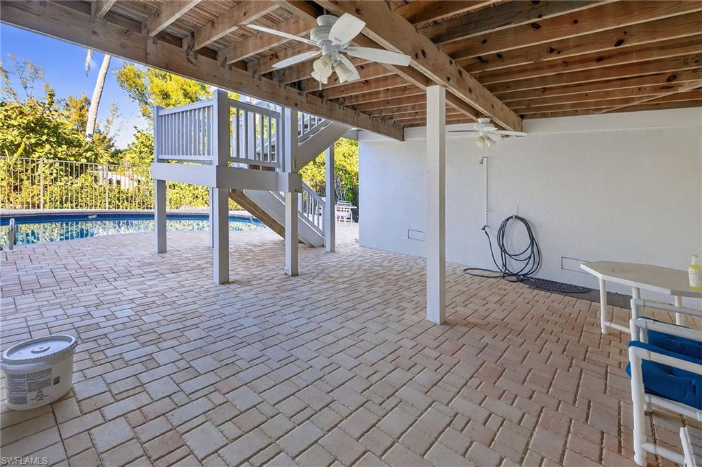View of patio featuring a ceiling fan and a deck