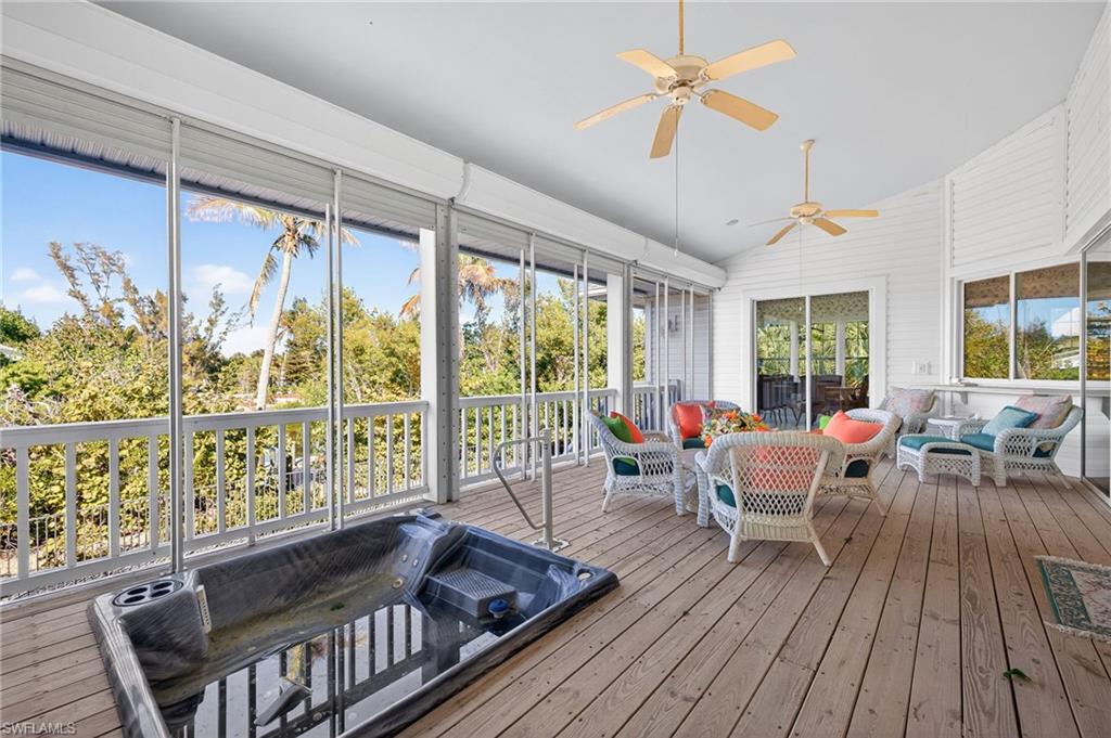 Sunroom featuring an outdoor living space, a ceiling fan, lofted ceiling, and a deck