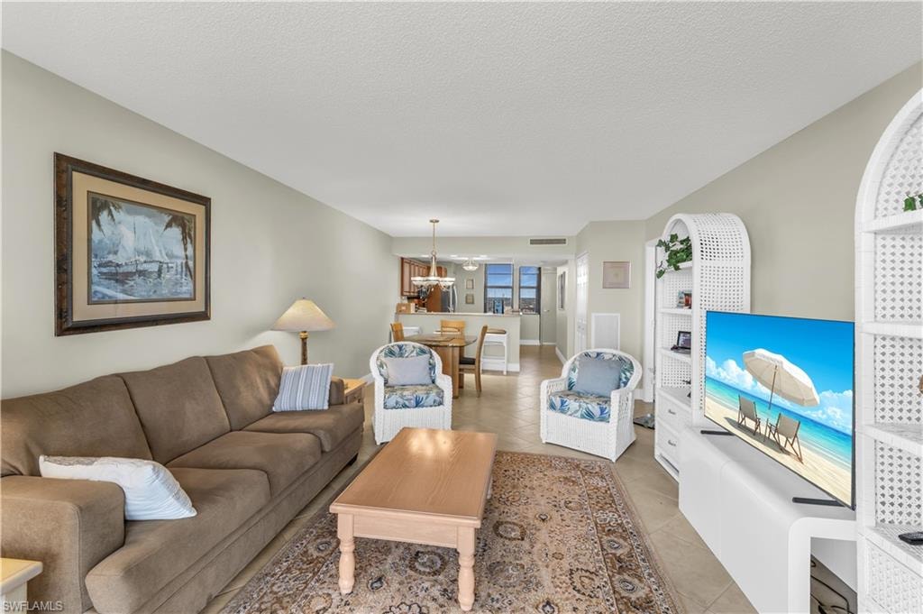 Living area featuring a textured ceiling and light tile patterned floors