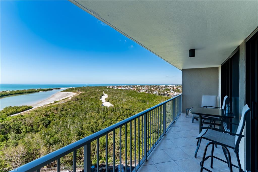 Balcony with view of water and beach