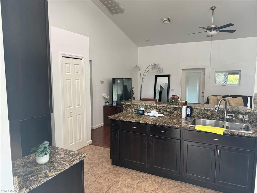 kitchen view from dining area, double sink, pantry and light tile patterned