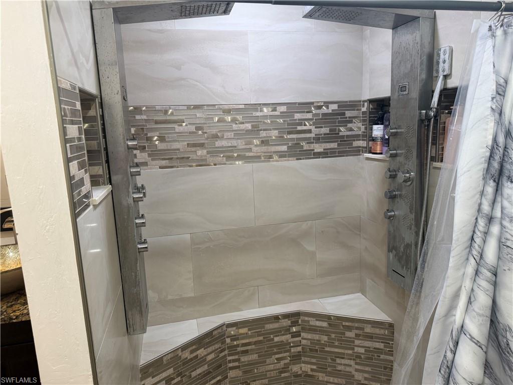 Master bathroom featuring  two separate waterfall dual head shower tower system