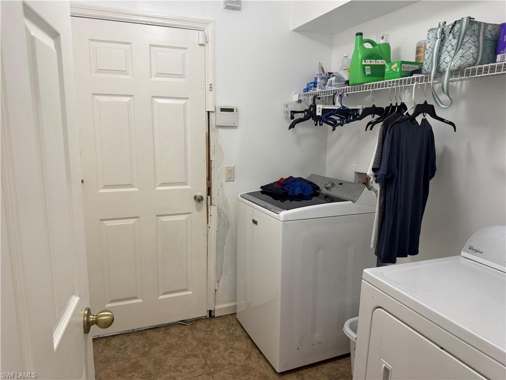 Laundry room featuring independent washer and dryer with damaged door and door frame