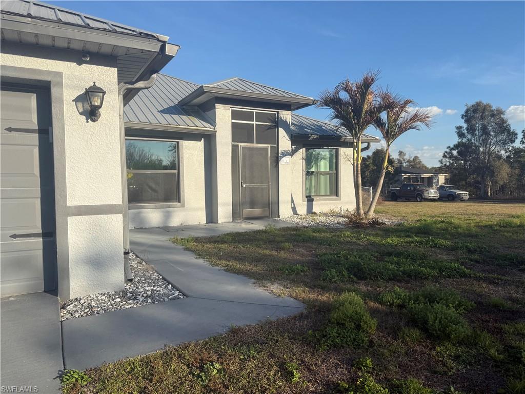 View of exterior entry featuring screened porch.