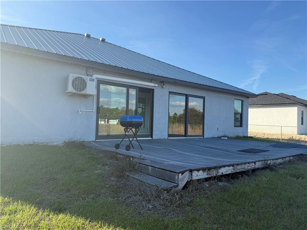 Rear view of house with wooden deck that needs repairs or replacement