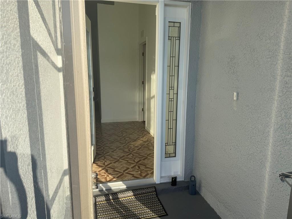Property front entrance inside of screened porch