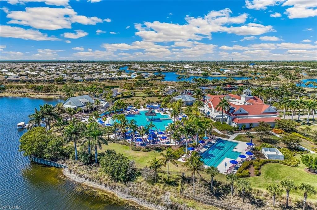 Bird's eye view of a pool area and a nearby body of water