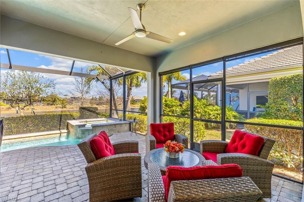 Sunroom / solarium featuring a ceiling fan, a jacuzzi, and healthy amount of natural light