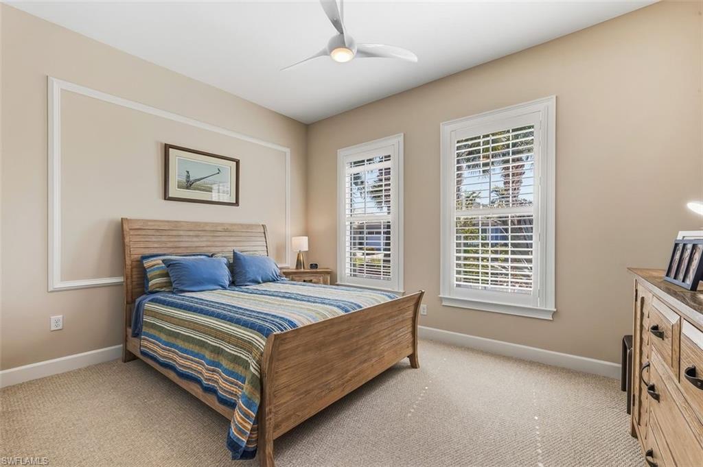Bedroom featuring light colored carpet and ceiling fan
